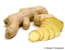 A ginger root and sliced up banana on the table.