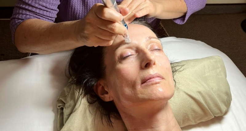 A woman getting her face waxed at the spa