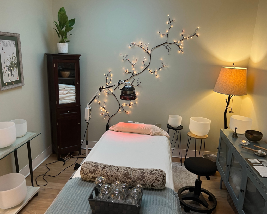 A bedroom with a bed, nightstand and lamps.